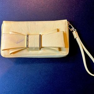 Betsy Johnson yellow zippered clutch with hand strap and bow